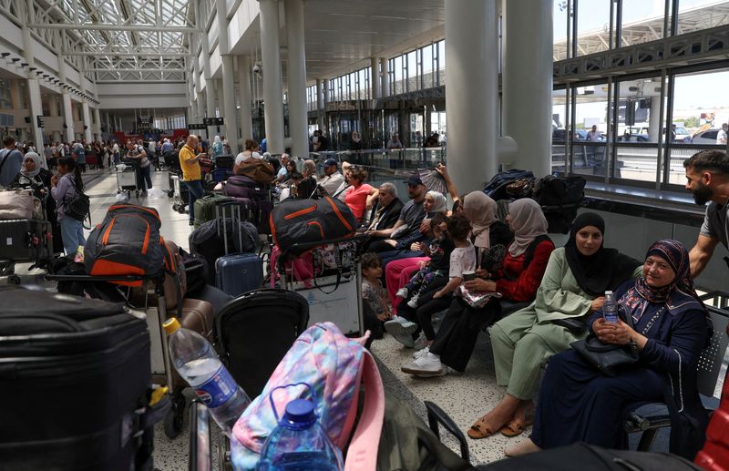 &copy; Reuters. FILE PHOTO: People sit near their luggages at the Beirut–Rafic Hariri International Airport, in Beirut, Lebanon July 29, 2024. REUTERS/Emilie Madi/File Photo