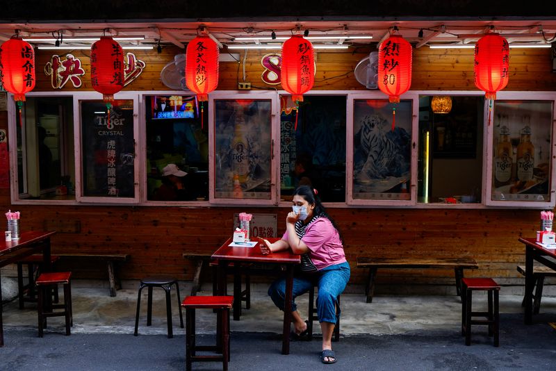 &copy; Reuters. FILE PHOTO: A person uses her mobile phone outside a restaurant in Taipei, Taiwan May 14, 2024. REUTERS/Ann Wang