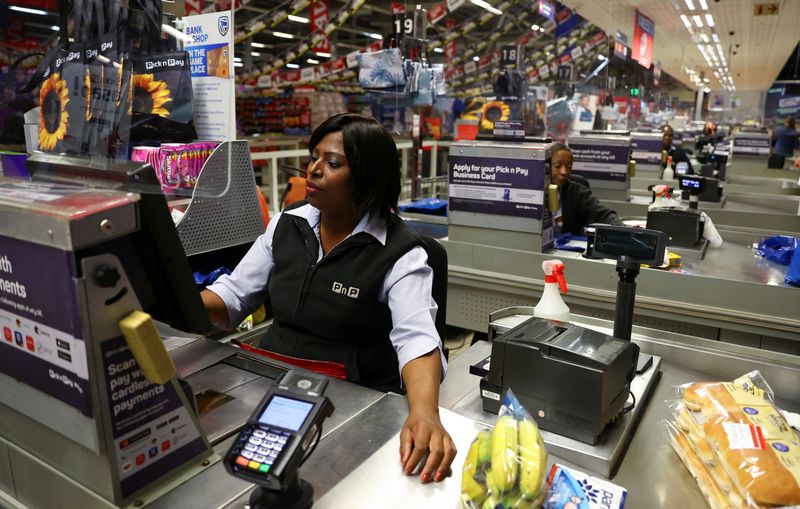 &copy; Reuters. FILE PHOTO: A teller is seen at a Pick n Pay store at Maponya mall in Soweto, South Africa, October 20, 2022. REUTERS/Siphiwe Sibeko/File photo