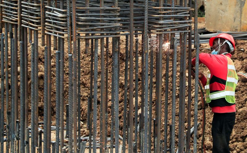 © Reuters. FILE PHOTO: A worker welds steel at the site of the construction of the Nairobi Expressway, undertaken by the China Road and Bridge Corporation (CRBC) on a public-private partnership (PPP) basis, along Uhuru highway in Nairobi, Kenya August 5, 2021. REUTERS/Thomas Mukoya/File photo