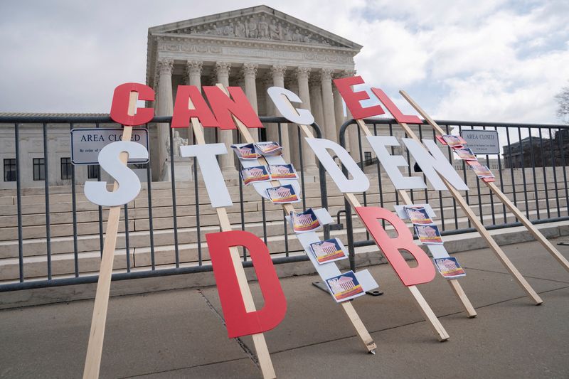 © Reuters. FILE PHOTO: A sign calling for student loan debt relief is seen outside the Supreme Court in Washington, U.S., February 28, 2023. REUTERS/Nathan Howard/File Photo