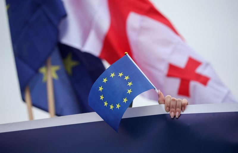 © Reuters. FILE PHOTO: A participant holds a EU flag during a procession in support of Georgia's membership in the European Union in Tbilisi, Georgia, December 9, 2023. REUTERS/Irakli Gedenidze/ File Photo