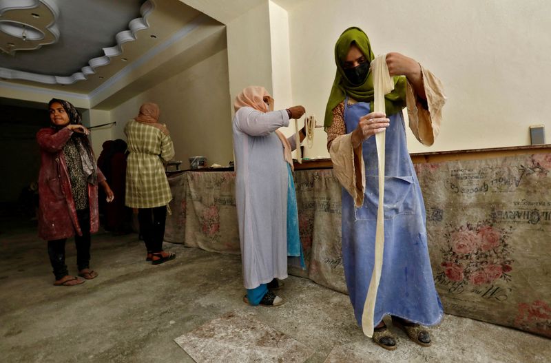 &copy; Reuters. FILE PHOTO: Afghan women prepare dough to make traditional cookies inside a bakery in Kabul, Afghanistan, May 5, 2024. REUTERS/Sayed Hassib/File Photo