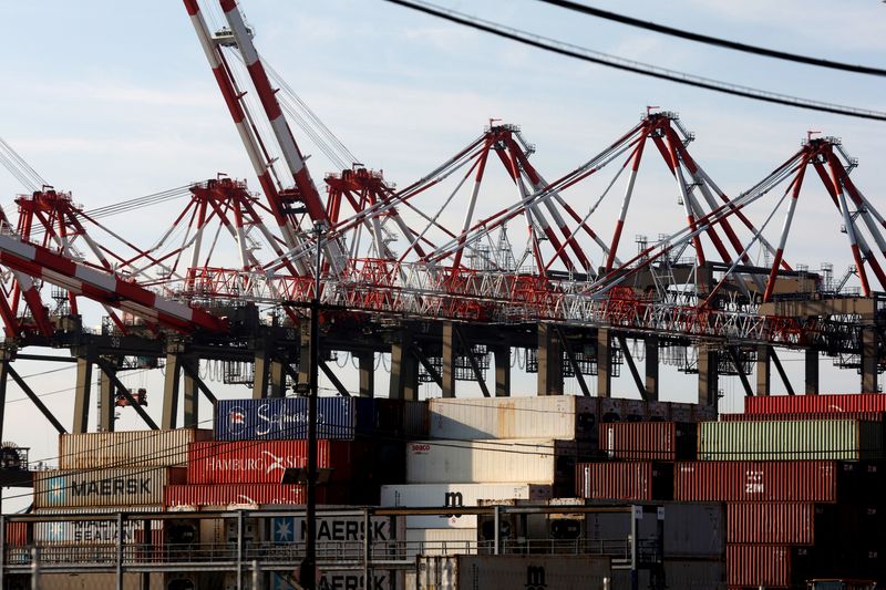 © Reuters. Containers are stacked beneath cranes at Port Newark Container Terminal as U.S. East Coast and Gulf ports resumed operations Friday after unionised dockworkers reached a tentative labour agreement with an employer group for a new contract, ending a three-day strike in Newark, New Jersey, U.S., October 4, 2024. REUTERS/Mike Segar