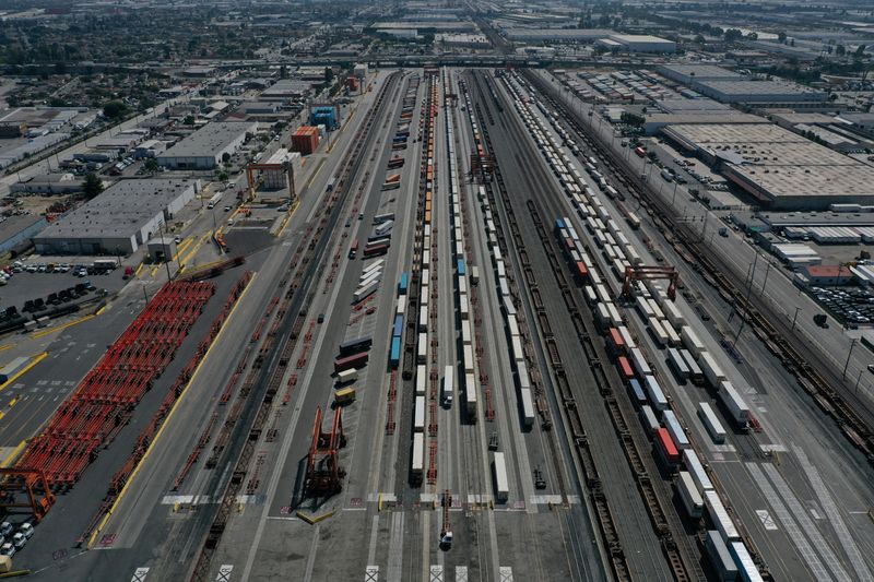 © Reuters. FILE PHOTO: An aerial view of shipping containers and rail freight trains ahead of a possible strike if there is no deal with rail workers unions at the BNSF Los Angeles Intermodal Facility rail yard in Los Angeles, California, US September 15 2022. REUTERS/Bing Guan/File photo