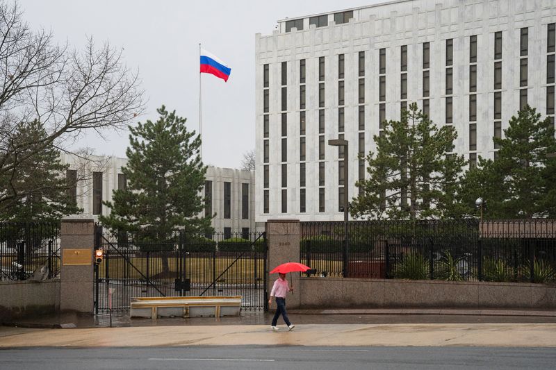 © Reuters. FILE PHOTO: A pedestrian walks with an umbrella outside the Embassy of the Russian Federation, near the Glover Park neighborhood of Washington, U.S., February 22, 2022. REUTERS/Tom Brenner/File Photo