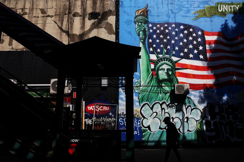 © Reuters. FILE PHOTO: A man walks in silhouette past the 207th Street subway station entrance in the Inwood neighborhood in New York City, U.S., June 18, 2024. REUTERS/Shannon Stapleton/File Photo