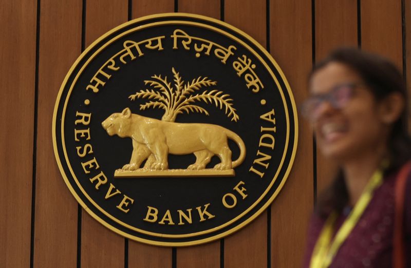 &copy; Reuters. FILE PHOTO: A woman walks past the Reserve Bank of India (RBI) logo inside its headquarters in Mumbai, India, April 6, 2023. REUTERS/Francis Mascarenhas/File Photo