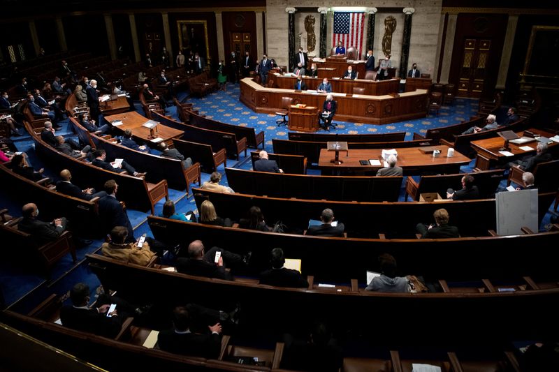 &copy; Reuters. FILE PHOTO: House members attend a reconvened joint session of Congress to certify the Electoral College votes of the 2020 presidential election in the House chamber in Washington, U.S., January 6, 2021. Caroline Brehman/Pool via REUTERS/File Photo