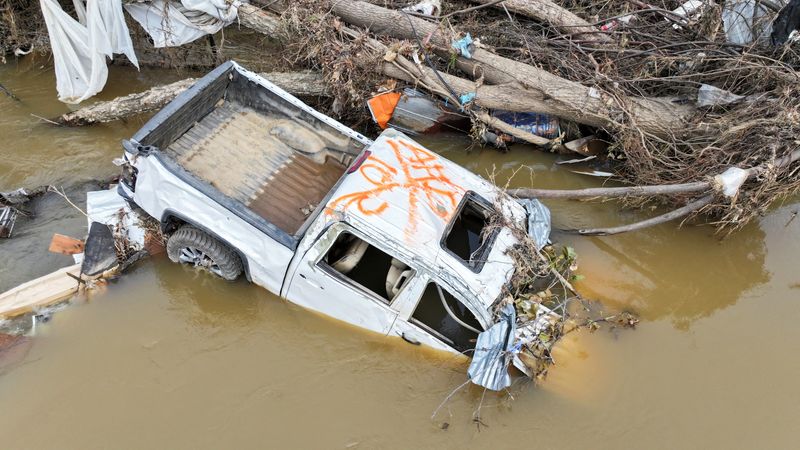 © Reuters. FILE PHOTO: A drone view shows a pick-up truck partially submerged in the Swannanoa River near Biltmore Village, after Storm Helene hit the area, in Asheville, North Carolina, U.S. October 5, 2024. REUTERS/Nathan Frandino/File Photo