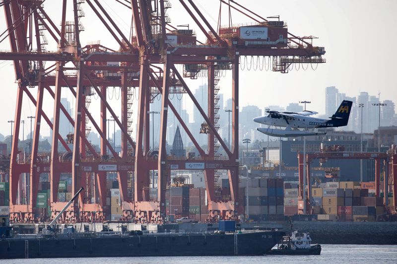 &copy; Reuters. FILE PHOTO: A float plane flies past containers and cranes at the Port of Vancouver, British Columbia, Canada, July 30, 2023. REUTERS/Chris Helgren/File Photo