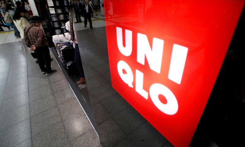 © Reuters. FILE PHOTO: Shoppers look at items at Fast Retailing's Uniqlo casual clothing store in Tokyo October 7, 2014. REUTERS/Yuya Shino/File Photo