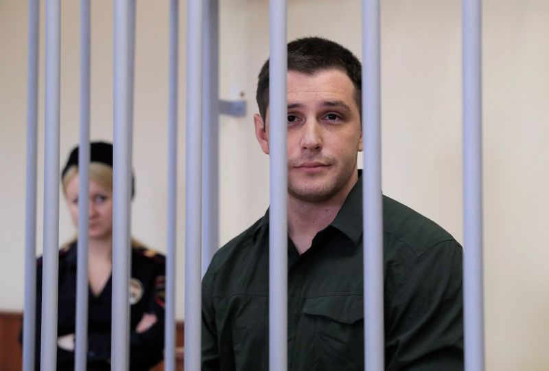 &copy; Reuters. FILE PHOTO: U.S. ex-Marine Trevor Reed, who was detained in 2019 and accused of assaulting police officers, stands inside a defendants' cage during a court hearing in Moscow, Russia March 11, 2020. REUTERS/Tatyana Makeyeva/File Photo