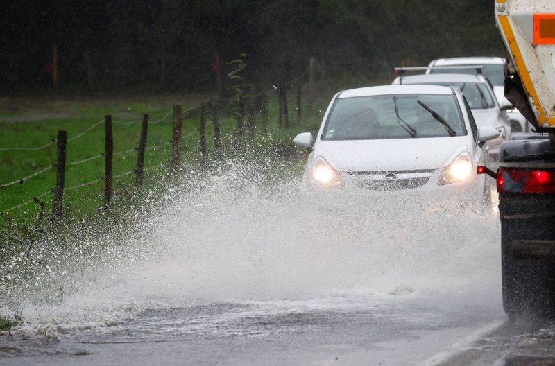 &copy; Reuters. FILE PHOTO: Vehicles drive along a flooded road as heavy rains continue in Vertou near Nantes, France October 9, 2024. REUTERS/Stephane Mahe/File Photo