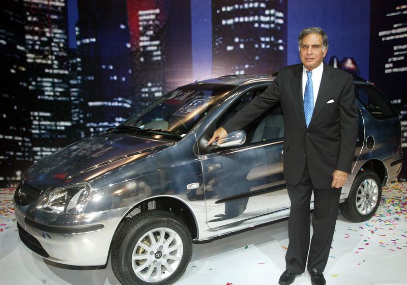 © Reuters. FILE PHOTO: Ratan Tata, chairman of Tata Motors Ltd, poses with company's new estate version Indigo 'Marina' car, during its launch in Bombay September 15, 2004. REUTERS/Punit Paranjpe/File photo