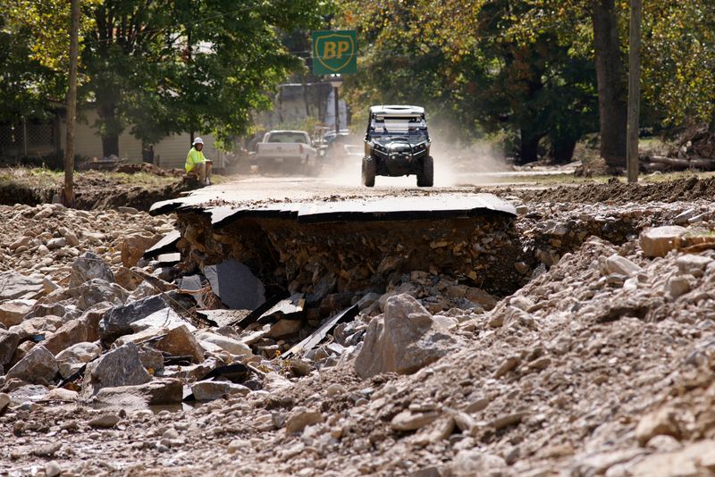 &copy; Reuters. FILE PHOTO: An all-terrain vehicle approaches a section of destroyed road in the aftermath of Hurricane Helene, in Barnardsville, North Carolina, U.S. October 2, 2024.  REUTERS/Jonathan Drake/File Photo