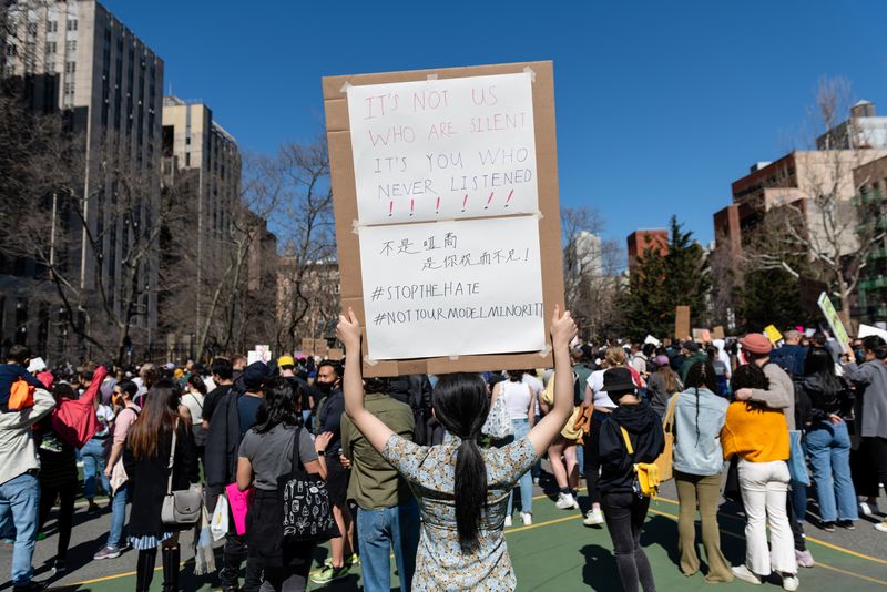 © Reuters. FILE PHOTO: A person holds up a sign during a Rally Against Hate to end discrimination against Asian Americans and Pacific Islanders in New York City, U.S., March 21, 2021. REUTERS/Eric Lee/File photo