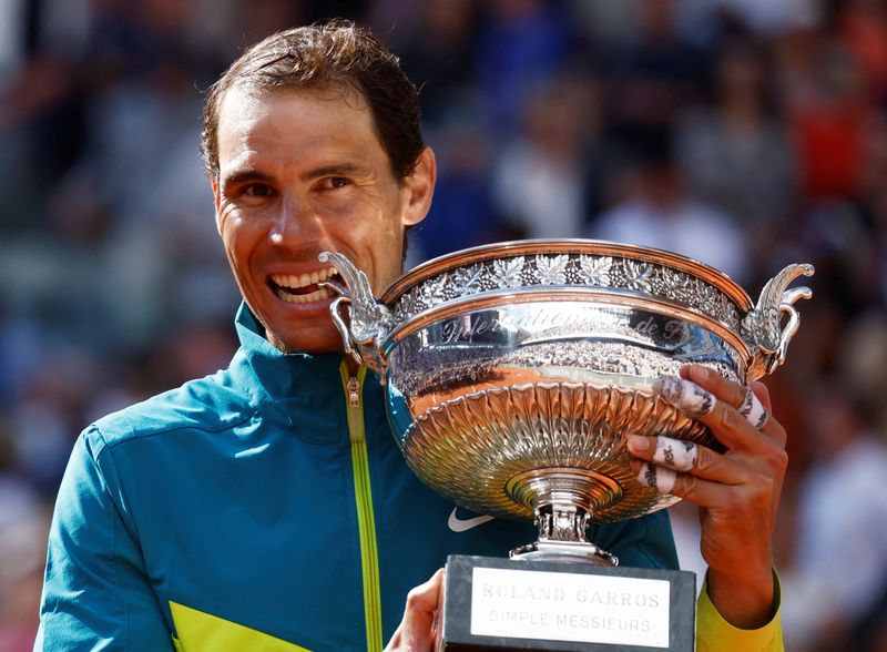 &copy; Reuters. FILE PHOTO: Tennis - French Open - Roland Garros, Paris, France - June 5, 2022 Spain's Rafael Nadal bites the trophy to celebrate winning the men's singles final against Norway's Casper Ruud REUTERS/Yves Herman/File Photo