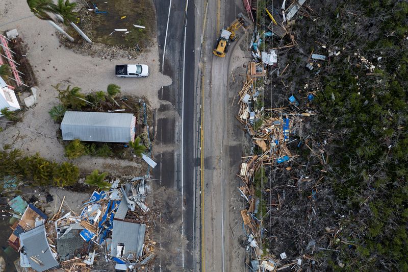 &copy; Reuters. A drone view shows a bulldozer removing debris from a road after Hurricane Milton made landfall in Matlacha, Florida, U.S., October 10, 2024. REUTERS/Ricardo Arduengo