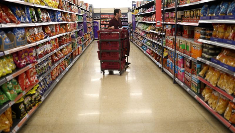 &copy; Reuters. An employee looks at the shelves inside a Sainsbury's supermarket in Cobham, Britain, October 2, 2024. REUTERS/Mina Kim/File Photo