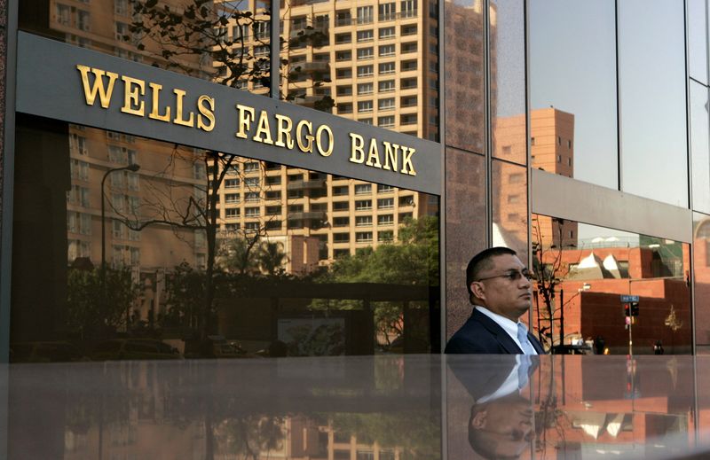 &copy; Reuters. FILE PHOTO: A man stands outside a Wells Fargo Bank building in Los Angeles October 14, 2008. REUTERS/Robert Galbraith/File Photo