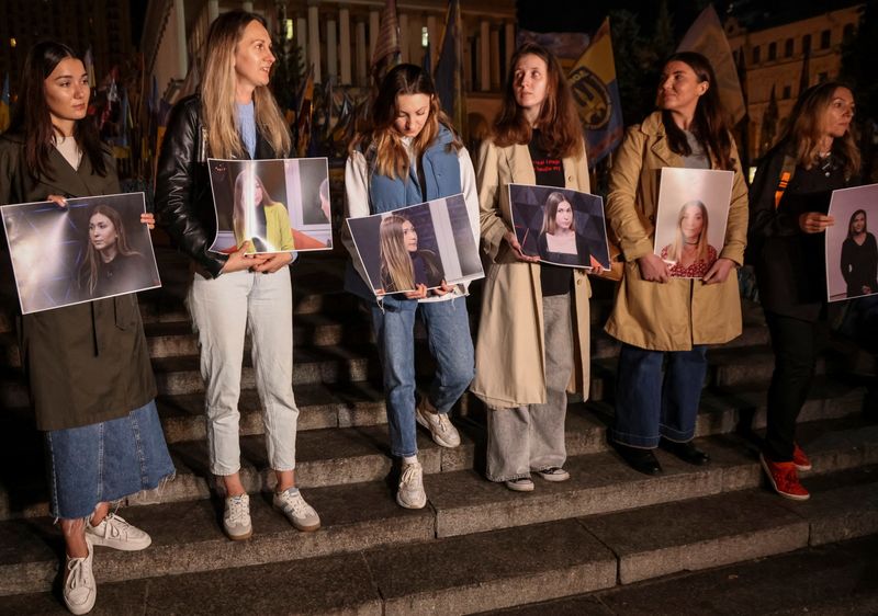 © Reuters. People hold portraits of Ukrainian journalist Victoria Roshchyna, who died in Russian captivity, as they take part in commemoration rally for her, amid Russia's attack on Ukraine, in Kyiv, Ukraine October 11, 2024. REUTERS/Stanislav Yurchenko