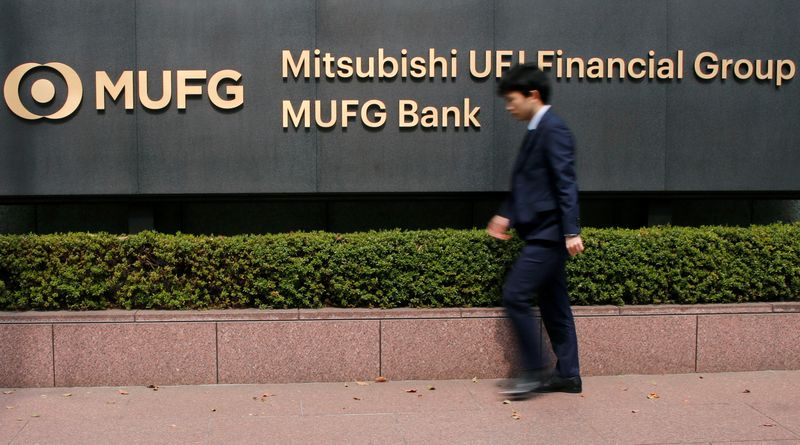 &copy; Reuters. FILE PHOTO: A man walks past a signboard of Mitsubishi UFJ Financial Group and MUFG Bank at its headquarters in Tokyo, Japan April 3, 2018. REUTERS/Toru Hanai/File Photo