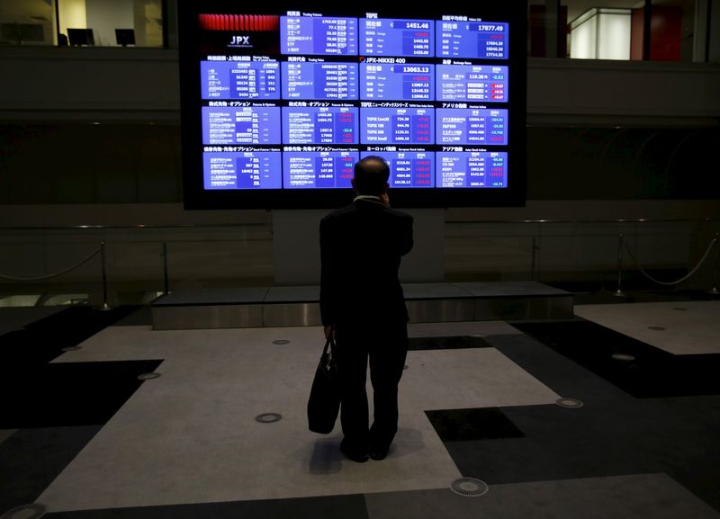 &copy; Reuters. FILE PHOTO: A man looks at an electronic board showing Japan's Nikkei average and related indices at the Tokyo Stock Exchange (TSE) in Tokyo August 26, 2015. REUTERS/Yuya Shino/File Photo