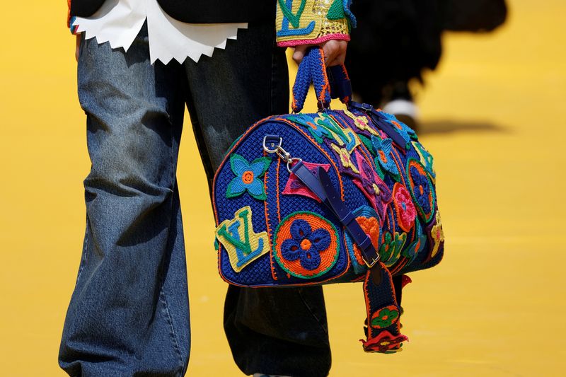 © Reuters. A model presents a bag creation by Louis Vuitton fashion house as part of their Spring/Summer 2023 collection show during Men's Fashion Week in Paris, France, June 23, 2022. REUTERS/Benoit Tessier/File Photo