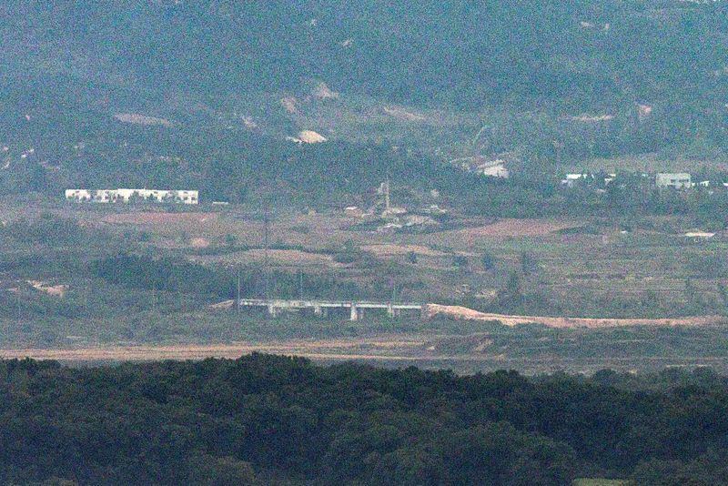 © Reuters. A mound of dirt is piled up near a structure on the road of the Gyeongui Line in the northern area of the Demilitarized Zone (DMZ), separating the two Koreas, in this picture taken from Paju, South Korea, October 14, 2024. Yonhap/via REUTERS 