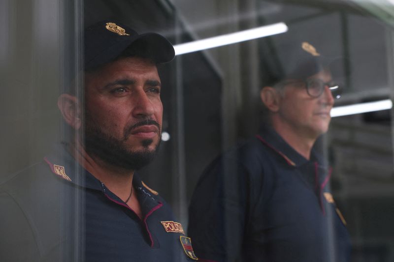 &copy; Reuters. FILE PHOTO: Italian police officers stand inside the reception camp at the port where Italy will process illegal migrants, in Shengjin, Albania October 11, 2024. REUTERS/Florion Goga/File Photo