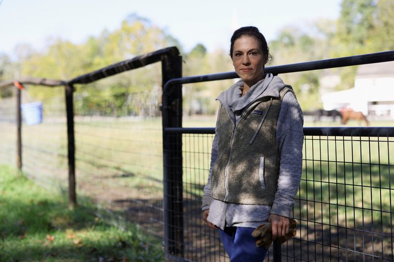 &copy; Reuters. Erika Worobec, who successfully sued to compel Washington County officials to notify voters if their mail-in or absentee ballot had a clerical error, poses for a portrait near the stables at her home in Cecil, Pennsylvania, U.S. October 11, 2024. REUTERS/