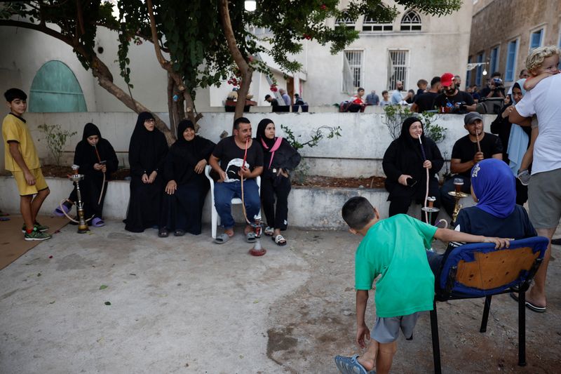 &copy; Reuters. FILE PHOTO: Displaced people sit in a school which was turned into a temporary shelter for them, during a visit by Hezbollah lawmakers, amid the ongoing hostilities between Hezbollah and Israel, in Beirut, Lebanon, October 9, 2024. REUTERS/Louisa Gouliama