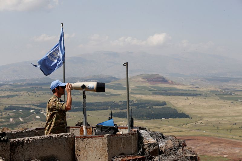 &copy; Reuters. FILE PHOTO: A United Nations Truce Supervision Organisation military observer uses binoculars near the border with Syria in the Israeli-occupied Golan Heights, Israel May 11, 2018. REUTERS/Baz Ratner/File Photo