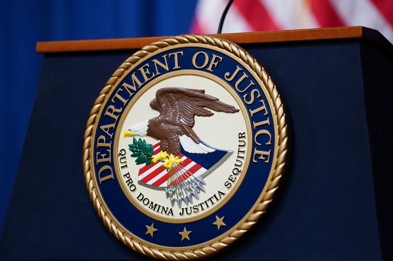 © Reuters. FILE PHOTO: The seal of the U.S. Justice Department is seen on the podium in the Department's headquarters briefing room before a news conference with the Attorney General in Washington, January 24, 2023.  REUTERS/Kevin Lamarque/File Photo