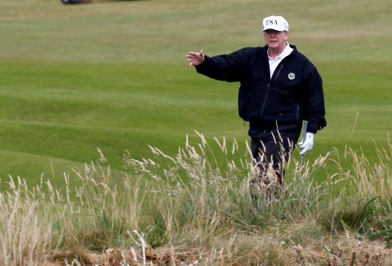 © Reuters. FILE PHOTO: Donald Trump gestures as he walks on the course of his golf resort, in Turnberry, Scotland  July 14, 2018.  REUTERS/Henry Nicholls/File Photo