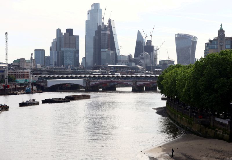 &copy; Reuters. A man stands on the bank of the River Thames in front of the city of London financial district, in London, Britain, May 18, 2022. REUTERS/Hannah McKay/File Photo