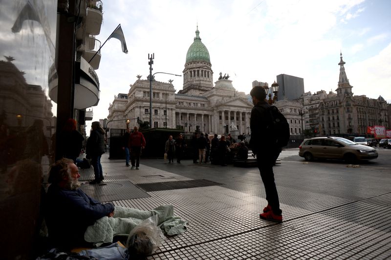 &copy; Reuters. FILE PHOTO: People walk near the National Congress on a day when members of Argentina's lower chamber meet to give the final vote on President Javier Milei's so-called 'Bases' bill, a mega-reform that will hand the government more sway over deregulating t