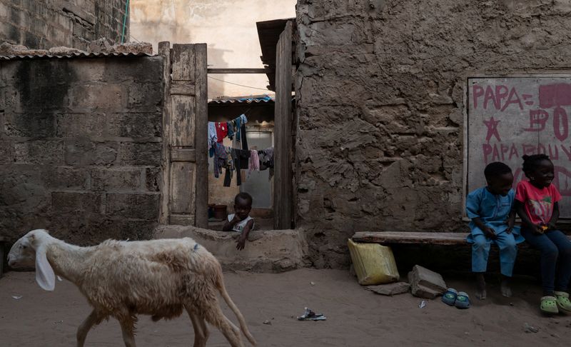 © Reuters. A child observes at the entrance of his family house on the outskirts of Dakar, Senegal, October 16, 2024.REUTERS/Zohra Bensemra