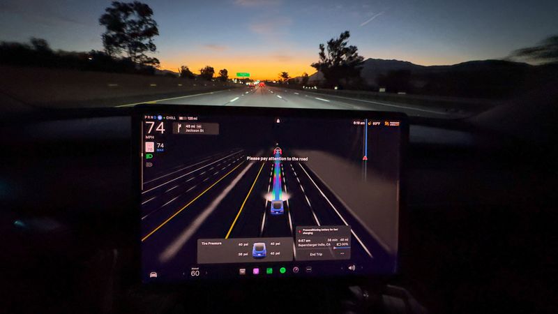 &copy; Reuters. A Tesla Model 3 using autopilot FSD is shown giving a warning on the screen to pay attention while driving on the highway in Palm Springs, California, U.S., October 12, 2024. REUTERS/Mike Blake/File Photo