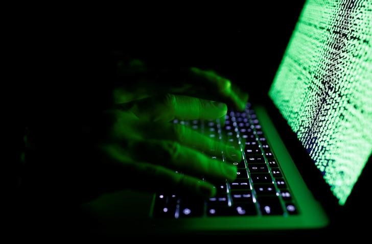 © Reuters. A man types on a computer keyboard in front of the displayed cyber code in this illustration picture taken on March 1,  2017.REUTERS/Kacper Pempel/Illustration/File Photo