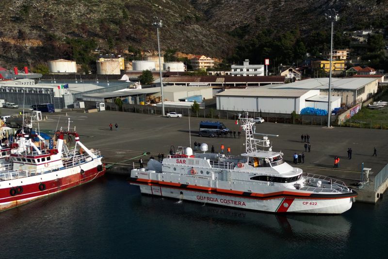 &copy; Reuters. A drone view shows an Italian coast guard vessel preparing to depart for Italy with migrants, who were intercepted at sea and later detained at a reception facility in Albania, after a court in Rome overturned their detention orders, in Shengjin, Albania,