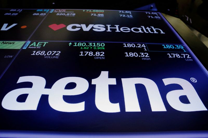 &copy; Reuters. FILE PHOTO: Logos of CVS and Aetna are displayed on a monitor above the floor of the New York Stock Exchange shortly after the opening bell in New York, U.S., December 5, 2017.  REUTERS/Lucas Jackson/File Photo