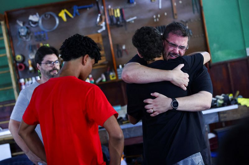 © Reuters. Relatives of victims of the accident that killed nine members of the rowing team of the social project Remar Para o Futuro hug each other at the club's headquarters, in the city of Pelotas, in the state of Rio Grande do Sul, Brazil, October 21, 2024. REUTERS/ Diego Vara