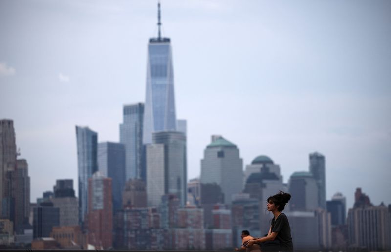 &copy; Reuters. FILE PHOTO: A woman enjoys the day in a park with the New York skyline in the background, in Hoboken, New Jersey, U.S. June 23, 2024. REUTERS/Agustin Marcarian/ File photo