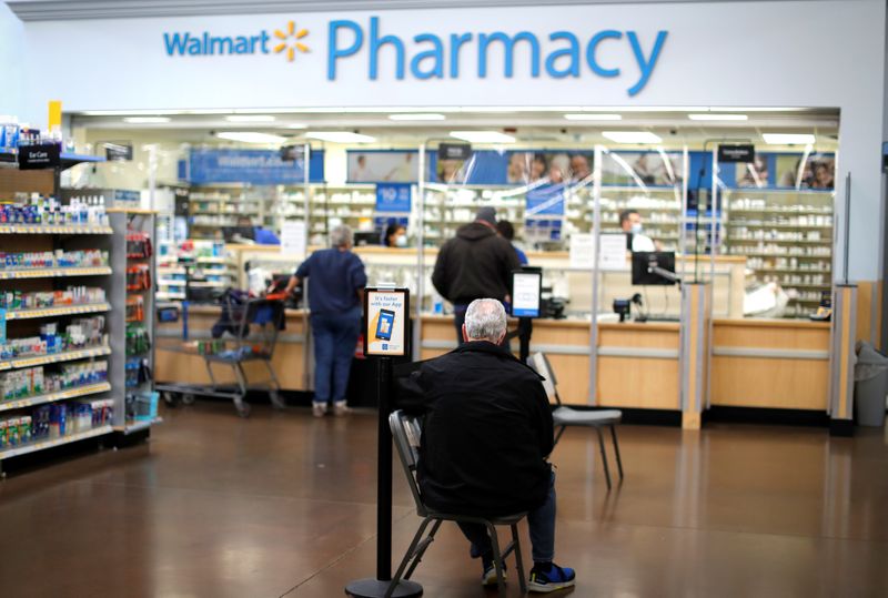 © Reuters. FILE PHOTO: A person waits at a Walmart Pharmacy in West Haven, Connecticut, U.S., February 17, 2021. REUTERS/Mike Segar/File Photo