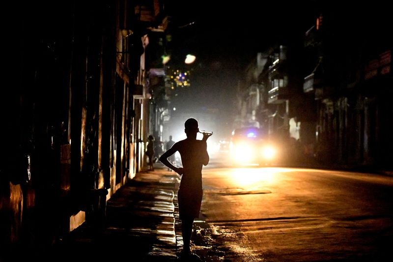 © Reuters. FILE PHOTO: People stand in the street at night as Cuba is hit by an island-wide blackout, in Havana, Cuba, October 18, 2024. REUTERS/Norlys Perez/File Photo