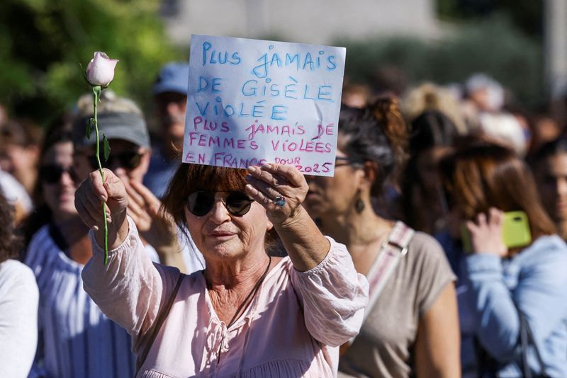 © Reuters. A woman holds a sign that reads 