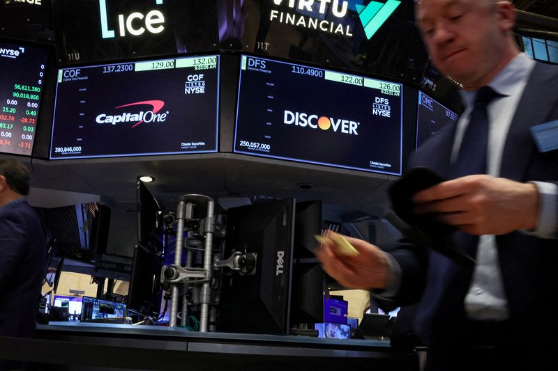 &copy; Reuters. FILE PHOTO: Screens display the logos and trading information for Capital One Financial and  Discover Financial as traders work on the floor at the New York Stock Exchange (NYSE) in New York City, U.S., February 20, 2024.  REUTERS/Brendan McDermid/File Ph