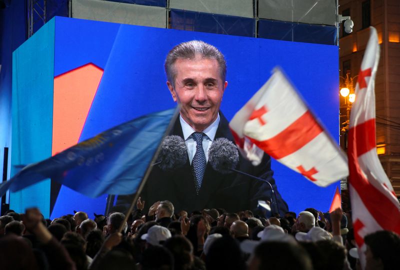 © Reuters. Founder of the Georgian Dream party Bidzina Ivanishvili is seen on a screen as he attends a final campaign rally held by the party's supporters ahead of the upcoming parliamentary elections in Tbilisi, Georgia October 23, 2024. REUTERS/Irakli Gedenidze